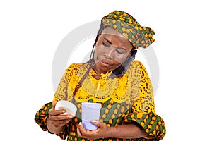 close up of a mature beautiful businesswoman talking on the mobile phone and holding a jug of milk
