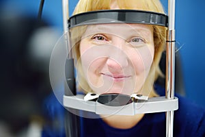 Close up mature female patient during visit by oculist for vision checkup