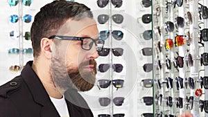 Close up of a mature man examining glasses for sale on the display