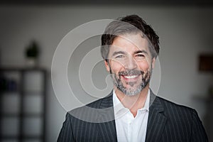 Close Up Of A Mature Man Smiling At The Camera. He is a CEO. Good looking businessman.