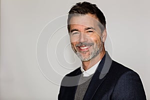 Close Up Of A Mature Man Smiling At The Camera. He is a CEO. Good looking businessman. Isolated on white.