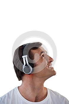 Close-up of mature man wearing headphones looking up