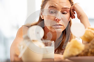 Close up of mature woman with facial wrinkles having food allergy