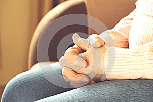 Close up of mature womans hands. Health care giving, nursing home. Parental love of grandmother. Old age related diseases.