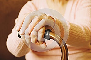 Close up of mature womans hands. Health care giving, nursing home. Parental love of grandmother. Old age related diseases.