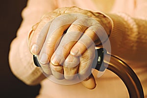 Close up of mature womans hands. Health care giving, nursing home. Parental love of grandmother. Old age related diseases.