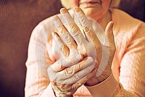 Close up of mature womans hands. Health care giving, nursing home. Parental love of grandmother. Old age related diseases.