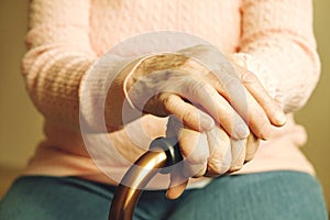 Close up of mature womans hands. Health care giving, nursing home. Parental love of grandmother. Old age related diseases.