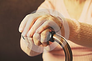 Close up of mature womans hands. Health care giving, nursing home. Parental love of grandmother. Old age related diseases.