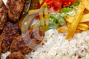 Close-up of meatballs with french fries, rice