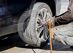 Close up of mechanic changing car`s tyre.