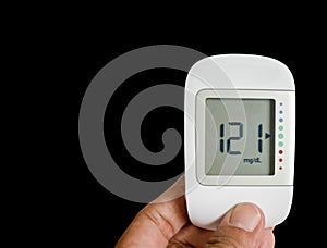 Close up Medical device, digital blood glucose test use to measure patient blood glucose at home or hospital isolated on black. photo