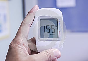 Close up Medical device, digital handheld blood glucose test use to measure patient blood glucose at home or hospital.