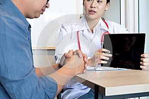 Close up medical doctor in white uniform gown coat interview and filling up an application form while consulting patient, medical