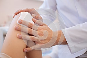 Close up of a medical dressing being pressed to the wound