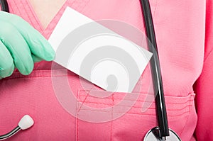 Close-up of medical nurse lady holding blank business card