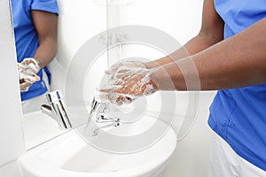 close up medical staff washing hands