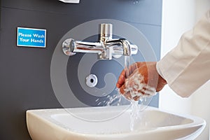 Close Up Of Medical Staff Washing Hands