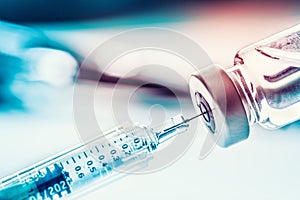 Close-up medical syringe with a vaccine photo