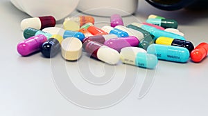 Close up medicine bottles with colorful tablets, pills, capsules drugs using for treatment and cure the disease.