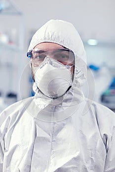 Close up of medicine engineer wearing face mask and suit photo