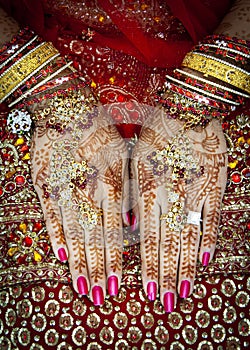 Close up of Mehndi tattoos on the hands of a Hindu or Sikh bride