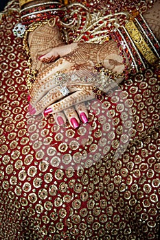 Close up of Mehndi tattoos on the hands of a Hindu or Sikh bride i