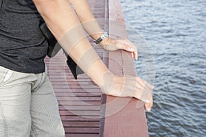 Close up men chill out on wooden bridge at riverside