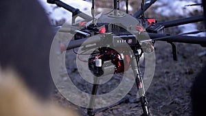 Close-up of men prepared quadcopter for flight. Clip. Two men admire latest version of quadcopter with powerful motors