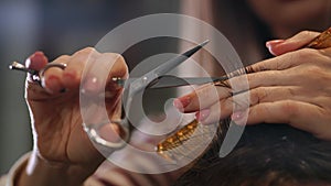 Close up of men`s hair cutting scissors in a beauty salon. Frame. Close up of a haircut at a hair saloon. Professional