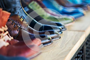 Close up on mens leather shoes in the row