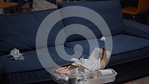 Close up of messy table with leftover in empty unorganized living room