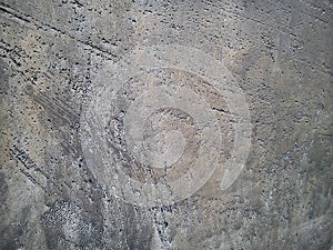 Close-up of a metal alloy with voids from entrained air in gray-gold colors. Alien surface with craters photo