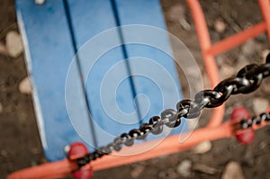 Close-up of a metal chain baby swing.