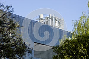 Close up metal chimneys on the factory roof.