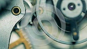 Close up of metal cogs moving in a watch mechanism