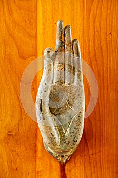 A close up of metal door handle in the shape of image of Buddha`s palm