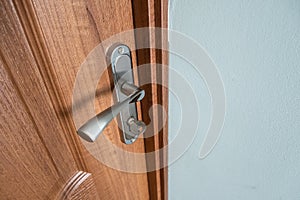 Close up of a metal door handle on wooden doors