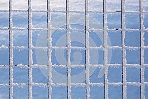 Close-up of a metal fence covered with beautiful frost