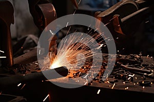 close-up of metal forging, with sparks flying and hammers pounding