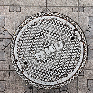 Close-up of the metal manhole cover