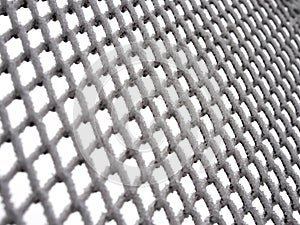 Close-up metal mesh covered with a thick layer of snow in the cells