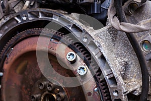 Close-up of a metal old clutch disc of an automatic transmission of a car during maintenance of a car at a station with corrosion