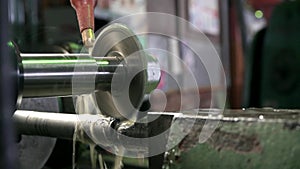 Close-up of metal pipe cutting. Stock footage. Metal pipe is cut with circular saw on factory machine and cooled with