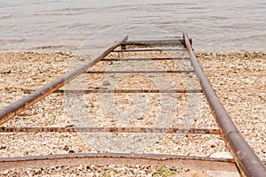 Close-up metal pipes for descent of boats on water.