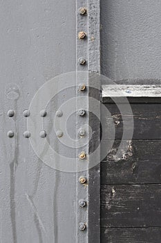 Close-up of metal plates and wooden panel