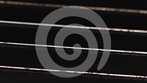 Close up of metal rods inside the oven with open fire. Stock footage. Dirty steel rods with fat isolated on black