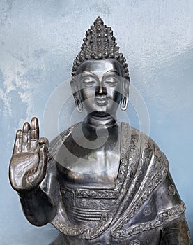 Close up of metal statue of Buddha.