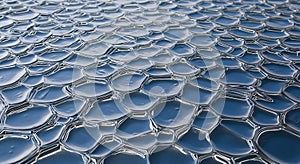 Close-up of metallic hexagonal honeycomb pattern reflecting light
