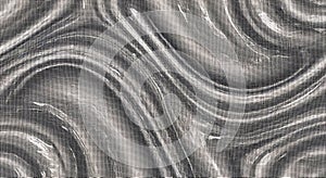 Close-up of metallic swirling pattern with reflective surface